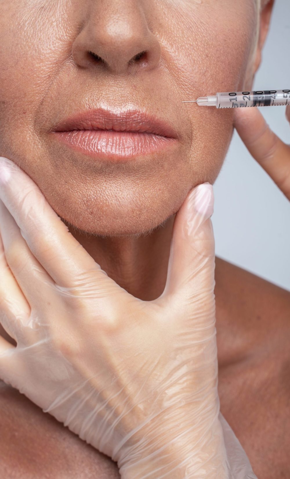 Sterile equipment. Senior lady visiting clinic while smoothing her wrinkles